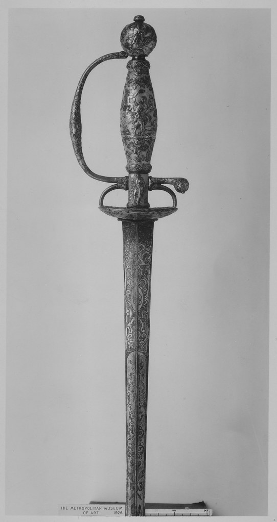 An antique small-sword with an engraved hilt and blade, photographed in black and white.